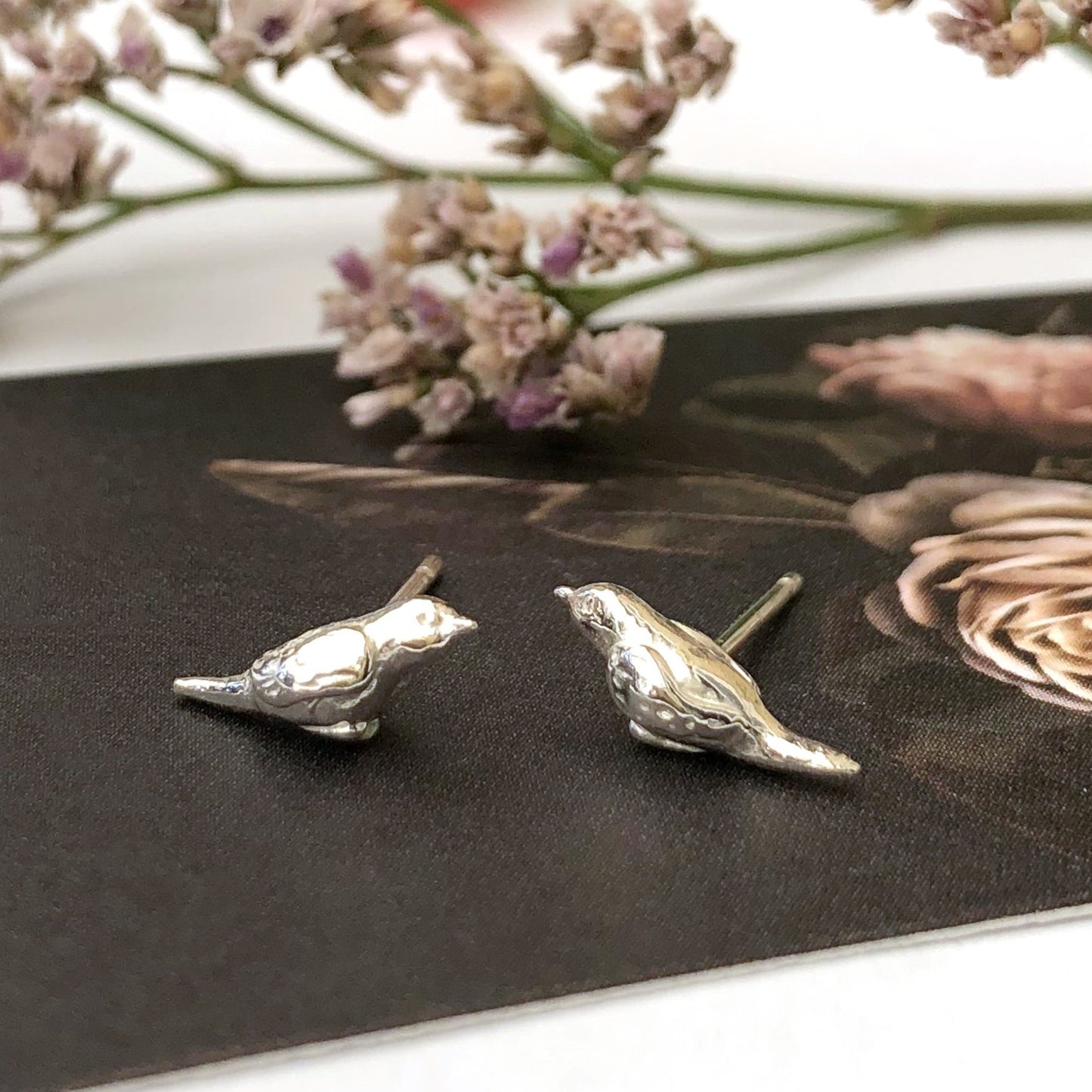sterling silver tiny robin bird stud earrings on flower card